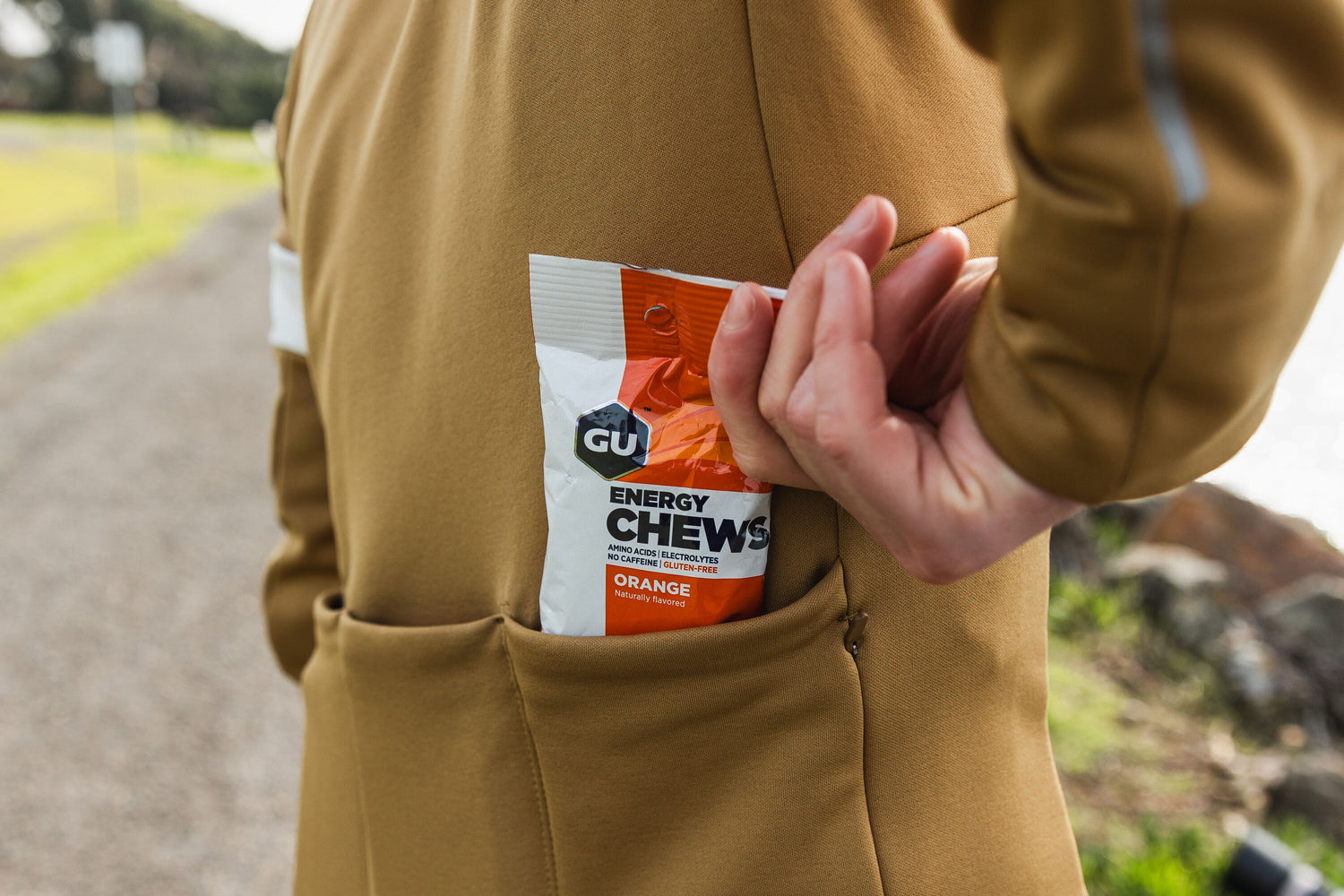 cyclist pulling orange energy chews out of pocket