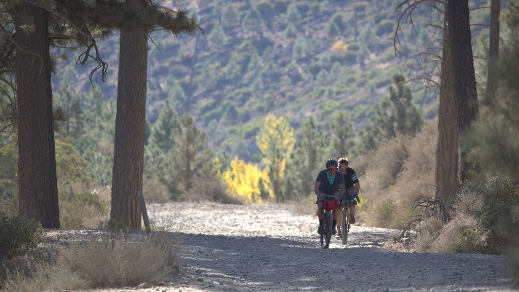 Cyclists riding gravel through Sierra Valley